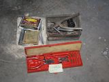 a box of tools sitting on the floor next to a pair of scissors