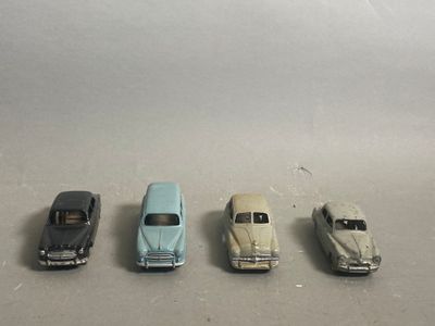 five toy cars lined up in a row on a table