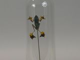 a glass dome with a flower inside of it