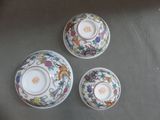 three plates and a bowl are sitting on a table