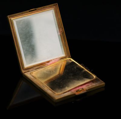 an image of a small mirror sitting on top of a table