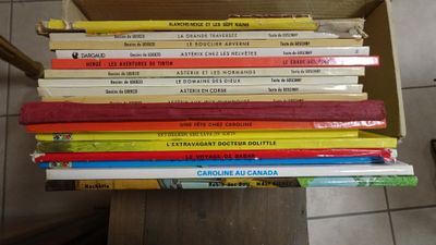 many books stacked on top of each other in a box