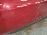 a close up of a red car in a garage