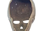 a brown mask with a skull on it on a white background
