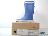 a pair of blue rain boots on top of a box