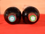 two bottles of wine that are sitting on a table