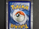 a close up of a pokemon card in a plastic case
