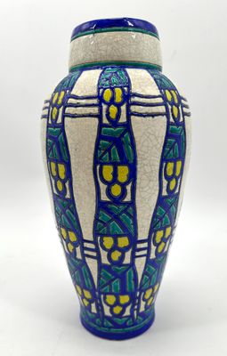 a blue and white vase sitting on a white surface