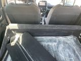 two seats in the back of a car with a tray in the back