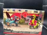 the box of the pokemon toy is open on a black surface