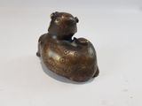 a small statue of a bear sitting on top of a table