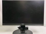the monitor is sitting on a stand on a white surface