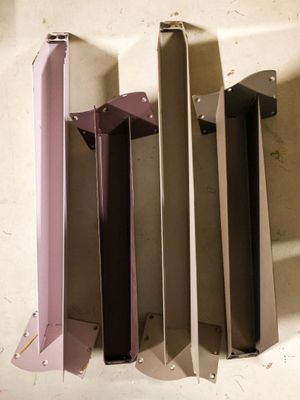 four pieces of metal that are sitting on a table