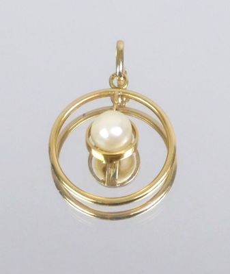 an image of a gold pendant with a pearl inside of it