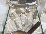 a silver tray with silverware in it on a table