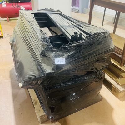a large pile of black plastic material on a pallet