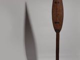 an old wooden paddle with a wooden handle on a white background