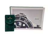 the rolex watch is in a box with a green velvet case