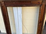a picture of a picture frame on the ground next to a wall