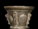 a vase that has shells on it on a black background