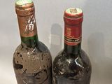 two bottles of wine sitting next to each other on a table