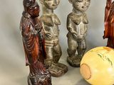 three figurines sitting next to each other on a table