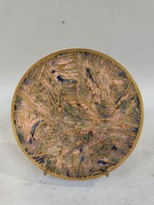 a picture of a decorative plate on a white surface