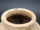 a close up of a clay vase with a black background