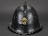 an old helmet with a gold leaf on the side