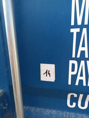 a sign on the side of a blue dumpster that says money tax payout