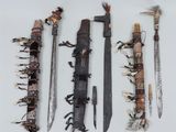 several different types of weapons are displayed on a white surface