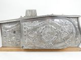 an old silver metal box on a wooden stand on a white background