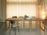 a dining room with a table and chairs in front of a large window