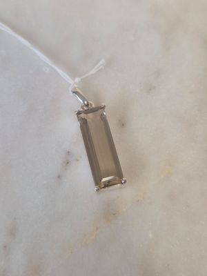 sterling silver pendant with a smoky quartz stone on a white marble surface