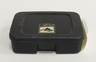 a black box with a sticker on it on a white surface