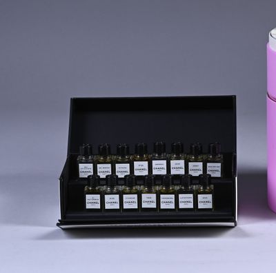 bottles of essential oils in a display case next to a container of essential oils