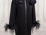 the coat is black and has feathers on it