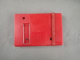 a red nintendo game case on a white surface