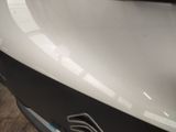 a close up of a car ' s front bumper with a sticker on it