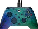 un gros plan d'une manette sur fond vert et bleu