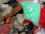 a pile of clothes and other items that are in a bin