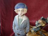 a figurine of a woman riding a horse with a bag