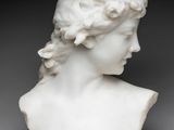 a white marble bust of a woman with braid hair
