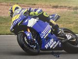 a man that is riding a motorcycle on a track