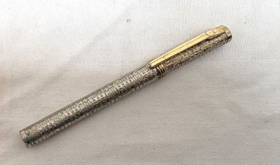 an image of a pen sitting on top of a piece of paper