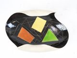 a black and white plate with a colorful design on it