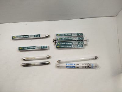 several pens and pencils are sitting on a table in a box