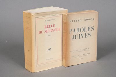 two books sitting on top of each other on a gray surface