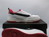 a pair of white and red sneakers sitting on top of a black box