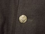 a close up of a piece of clothing with a coin in the pocket